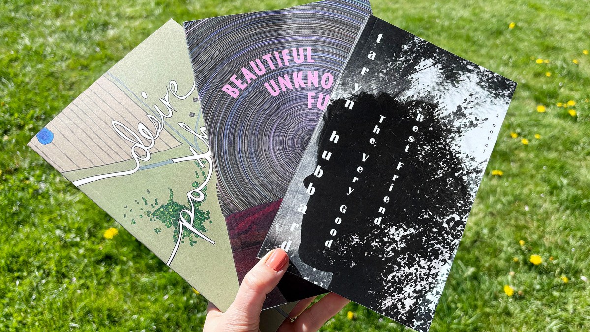 A fan of Taryn Hubbard's books set against a green lawn.